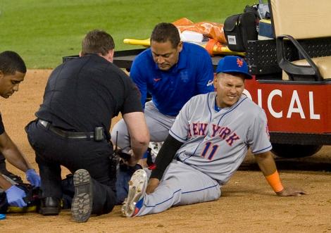 Mets shortstop Ruben Tejada winces as medical personnel immobilize his right leg that was injured by Dodger's Chase Utley's illegal and dangerous slide at second in the seventh inning. Photo by Paul Rodriguez, Orange County Register
